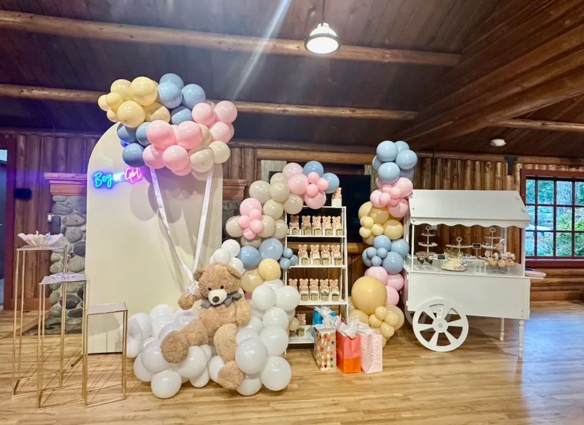 Pink and sage baby shower arch setup
