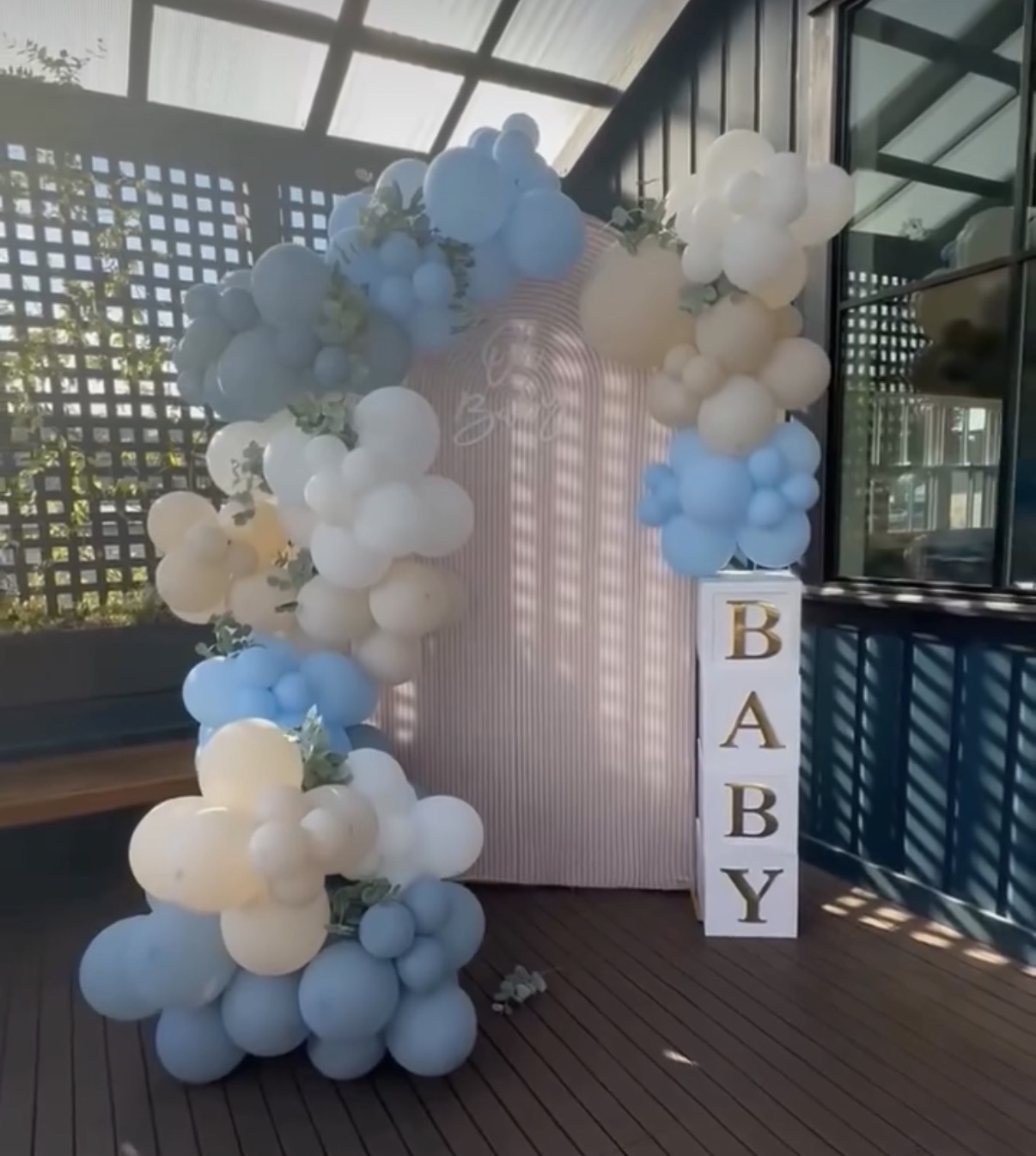 Blue floral arch baby shower setup