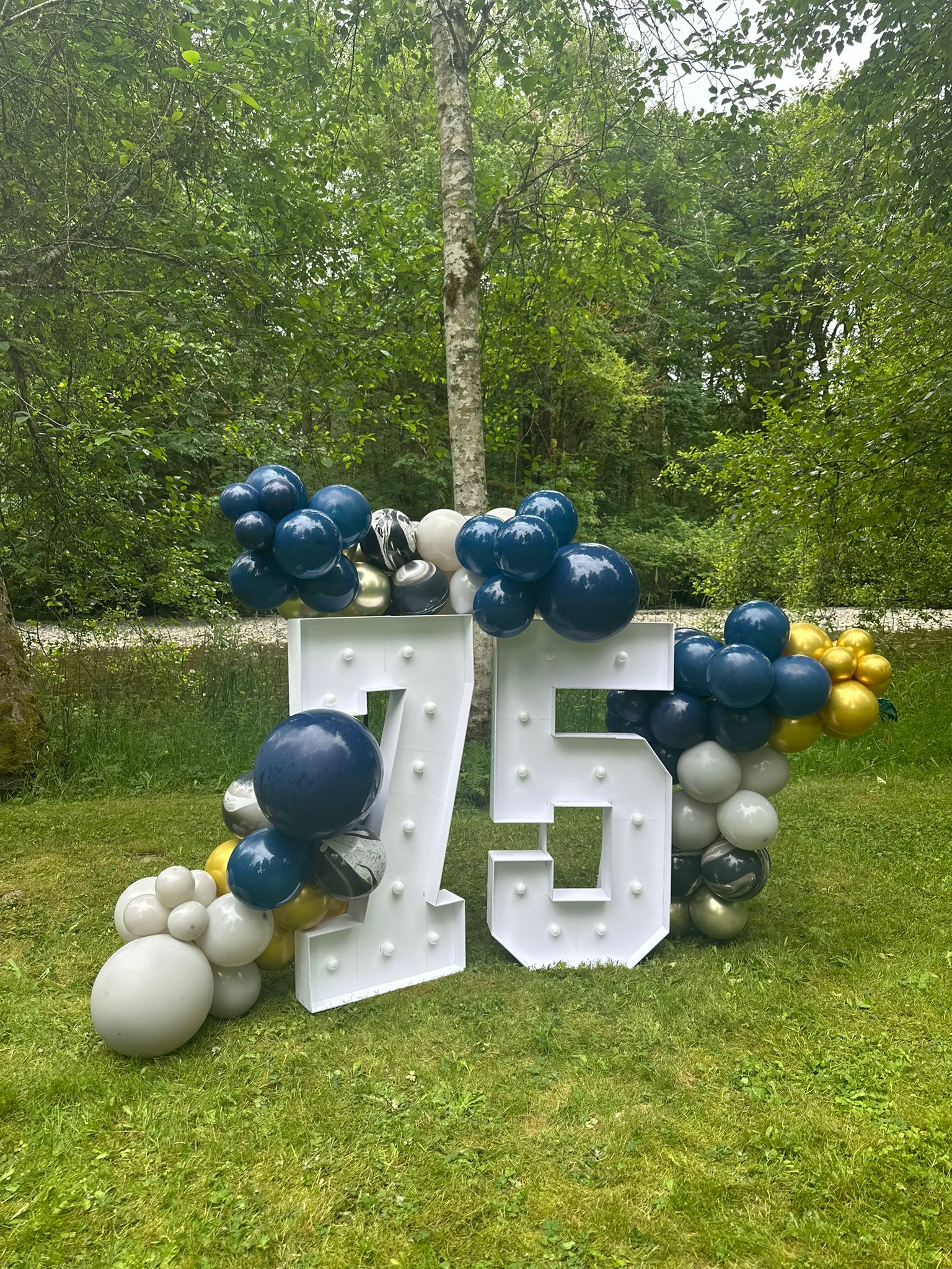 Orange daisy 1st birthday balloon arch