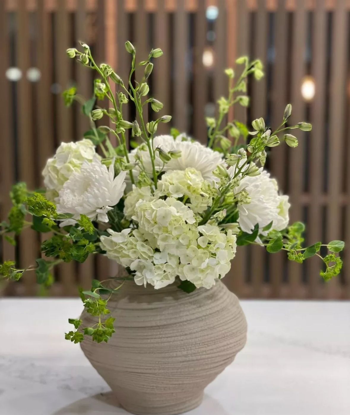 Face vase with pink and white flowers