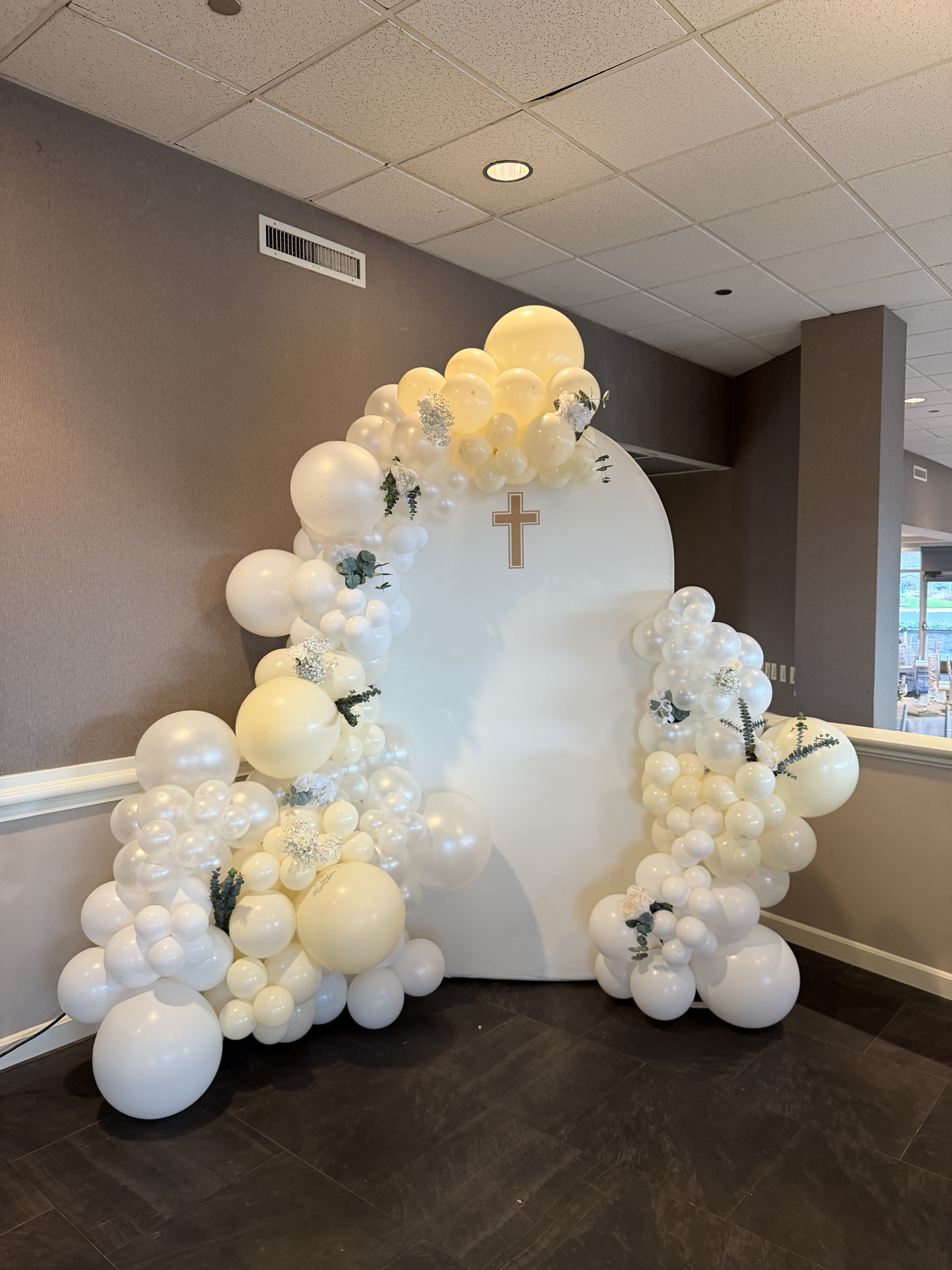 White black gold balloon arch in rustic barn venue